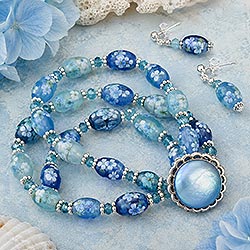 Unique, blue handmade three-strand bracelet using blue beads and buttons made from this jewelry pattern to make a coordinated jewelry set.