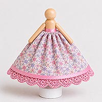 Floral doll pin dress with flesh-painted craft stick arms attached directly below the head at a slight downward angle, illustrating the proper arm placement for a handmade doll pin doll.