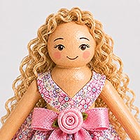 Instructional image illustrating how to add curly hair and draw simple facial features, including the eyes, eyelashes, eyebrows, smiling mouth, and rosy cheeks, to complete the face of a handmade doll pin doll.