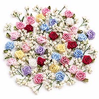 Tiny ribbon roses and miniature artificial baby's breath flowers in assorted colors on a white background for decorating handmade dolls, doll hats, doll dresses, and other doll making projects.